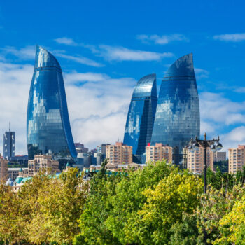 Flame towers in Baku cityscape.