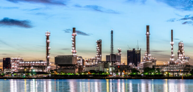 Oil and gas refinery industry plant with glitter lighting and sunrise in the morning, Factory of petroleum industrial, Power plant,Energy power station area. Industry 4.0