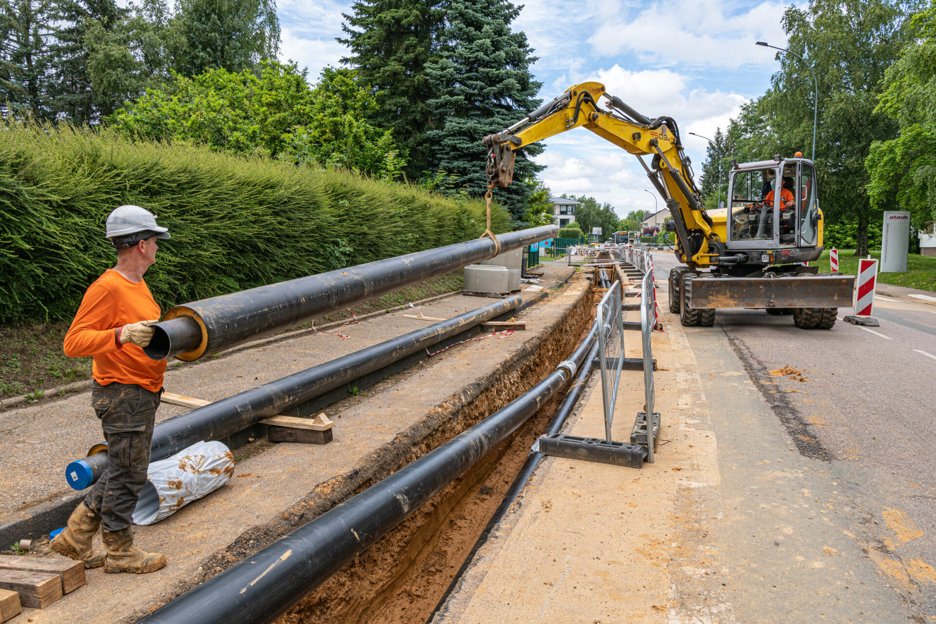 Installing district heating pipes.