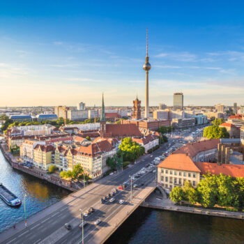 Berlin skyline panorama with TV tower and Spree river at sunset,