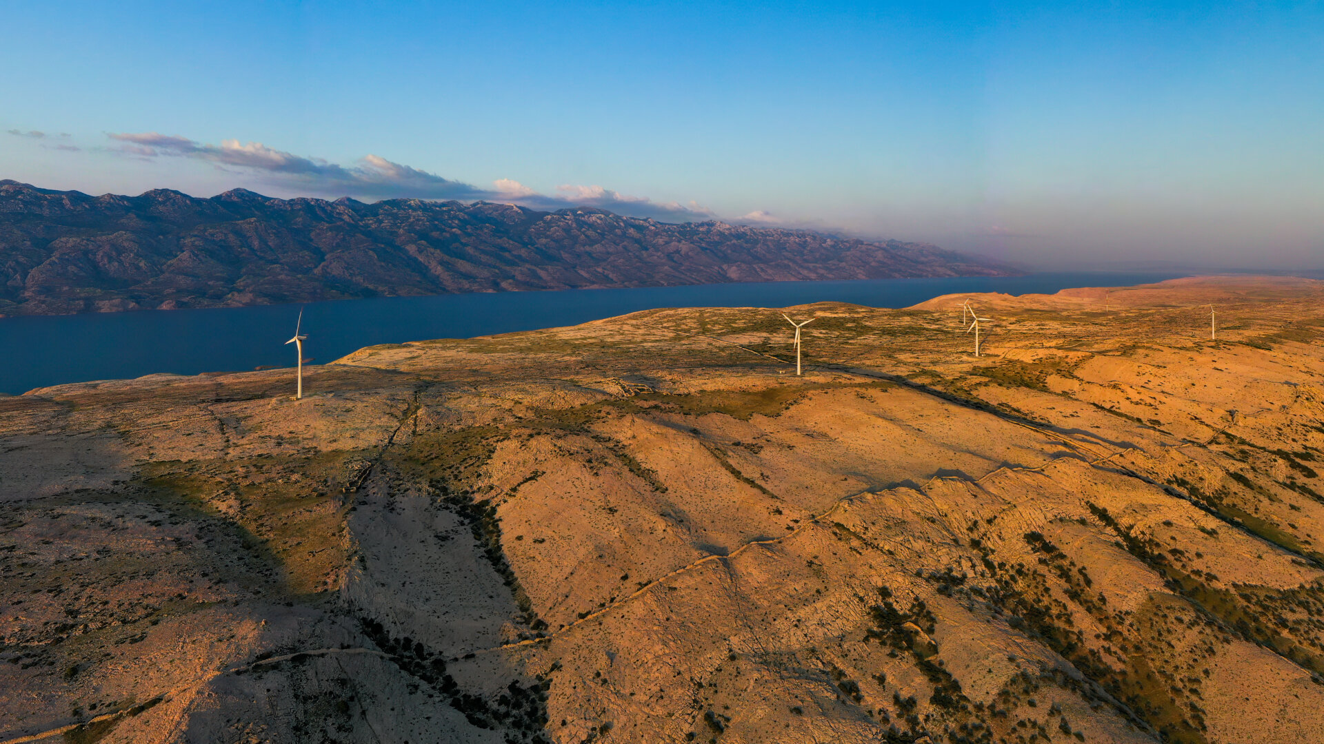 Aerial view of wind farm standing on the hill of island Pag surrounded by Adriatic sea, Croatia